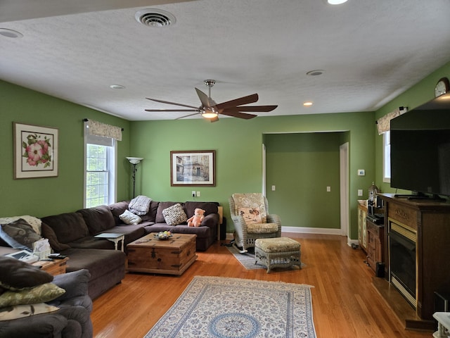 6733 Floyd Hwy S, Willis, VA 24380 - living room with light wood-style floors, a ceiling fan, recessed lighting, a glass covered fireplace, and baseboards