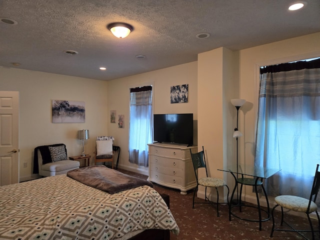 6733 Floyd Hwy S, Willis, VA 24380 - bedroom featuring baseboards, recessed lighting, dark colored carpet, and a textured ceiling