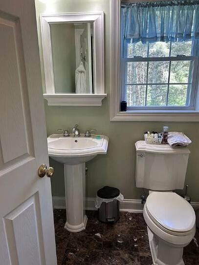 6733 Floyd Hwy S, Willis, VA 24380 - bathroom featuring toilet, baseboards, marble finish floors, and a sink