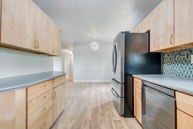 3271 Rasmont Rd, Roanoke, VA 24018 - kitchen with light brown cabinets, dishwasher, light wood finished floors, tasteful backsplash, and freestanding refrigerator