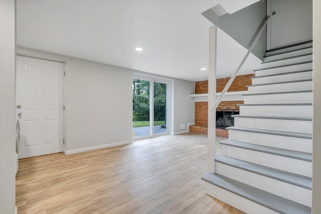 3271 Rasmont Rd, Roanoke, VA 24018 - unfurnished living room featuring baseboards, stairs, wood finished floors, recessed lighting, and a fireplace