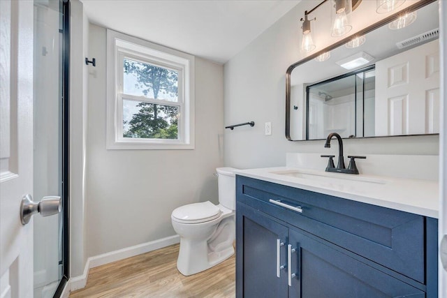 3271 Rasmont Rd, Roanoke, VA 24018 - bathroom featuring wood finished floors, vanity, toilet, baseboards, and a shower with shower door
