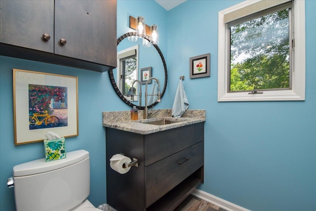 569 Sprinkle Rd, Fincastle, VA 24090 - half bathroom featuring vanity, toilet, healthy amount of natural light, and baseboards