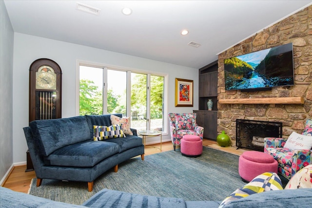 569 Sprinkle Rd, Fincastle, VA 24090 - living room with wood finished floors, baseboards, a stone fireplace, and recessed lighting
