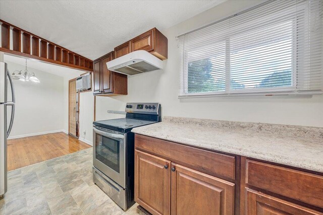 1046 Silverwood Rd NW, Roanoke, VA 24017 - kitchen featuring stainless steel appliances, range hood, plenty of natural light, and a wall unit AC