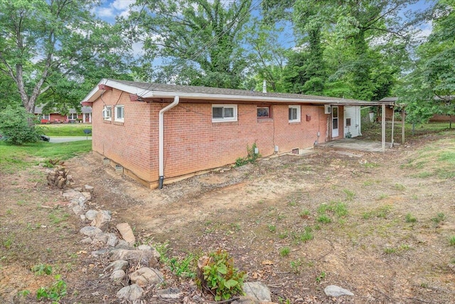 1046 Silverwood Rd NW, Roanoke, VA 24017 - view of side of property with brick siding, view of scattered trees, and a patio area