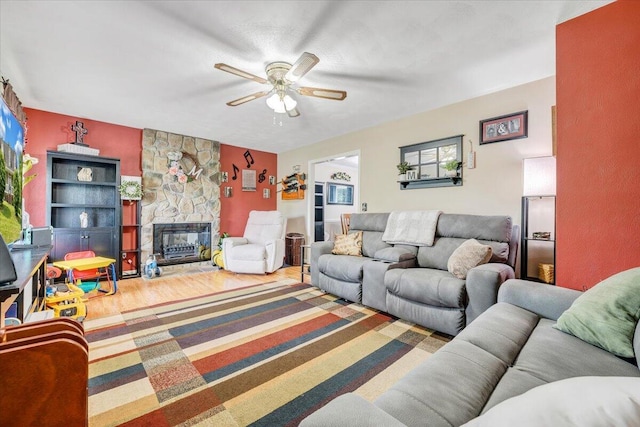 201 Jay Ridge Rd, Cloverdale, VA 24077 - living room featuring ceiling fan, a stone fireplace, and wood finished floors