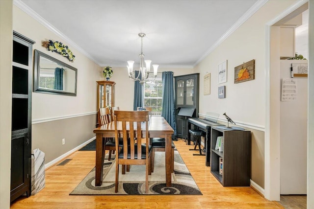 201 Jay Ridge Rd, Cloverdale, VA 24077 - dining room with a chandelier, ornamental molding, light wood-type flooring, and baseboards
