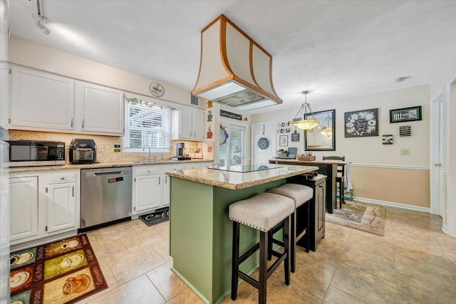 201 Jay Ridge Rd, Cloverdale, VA 24077 - kitchen featuring appliances with stainless steel finishes, a center island, white cabinets, backsplash, and light stone counters