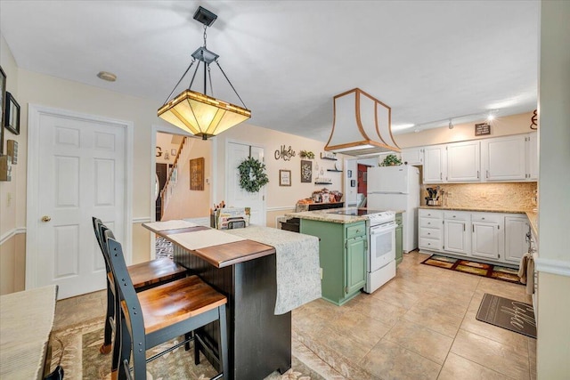 201 Jay Ridge Rd, Cloverdale, VA 24077 - kitchen featuring a kitchen island, white appliances, light countertops, tasteful backsplash, and white cabinetry