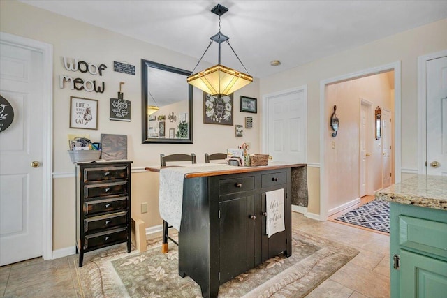 201 Jay Ridge Rd, Cloverdale, VA 24077 - kitchen with light countertops, hanging light fixtures, dark cabinetry, and baseboards