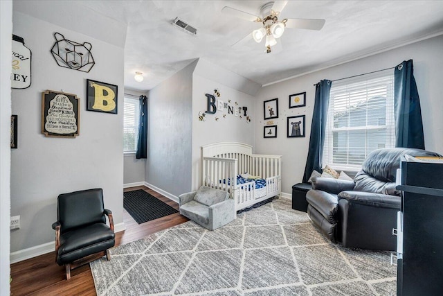 201 Jay Ridge Rd, Cloverdale, VA 24077 - bedroom with wood finished floors, a crib, baseboards, and a ceiling fan