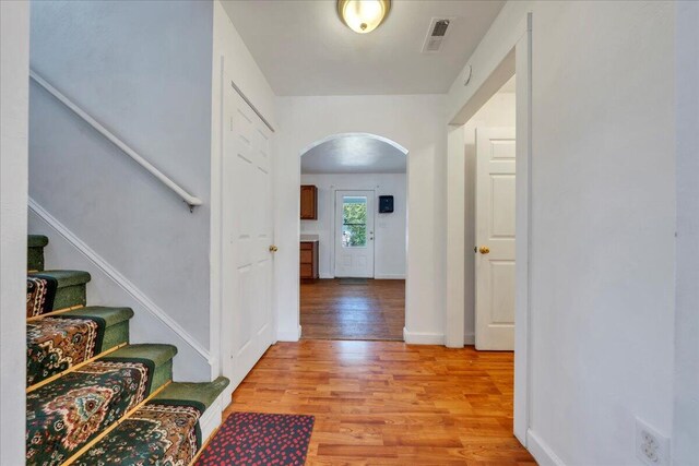 825 Day Ave SW, Roanoke, VA 24016 - entrance foyer with arched walkways, light wood-type flooring, stairway, and baseboards