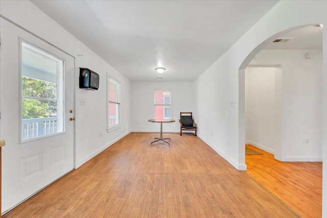 825 Day Ave SW, Roanoke, VA 24016 - entrance foyer with light wood-style flooring, arched walkways, and plenty of natural light