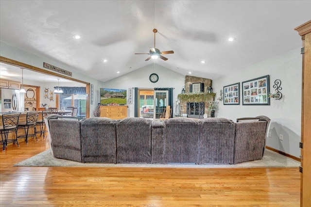 5335 Catawba Valley Dr, Catawba, VA 24070 - living area featuring ceiling fan, vaulted ceiling, light wood finished floors, a stone fireplace, and recessed lighting