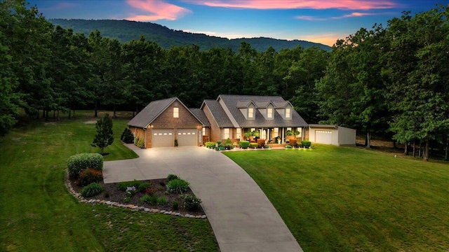 5335 Catawba Valley Dr, Catawba, VA 24070 - cape cod house featuring a porch, a yard, an attached garage, concrete driveway, and a view of trees