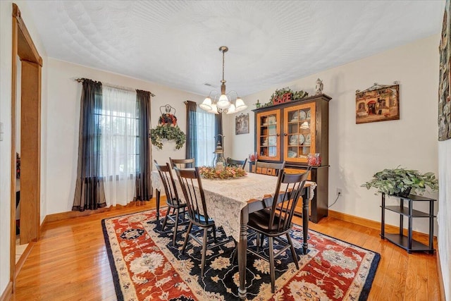 5335 Catawba Valley Dr, Catawba, VA 24070 - dining space with a chandelier and light wood-style flooring