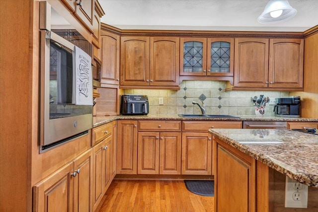 5335 Catawba Valley Dr, Catawba, VA 24070 - kitchen featuring brown cabinets, light stone counters, and light wood-style flooring