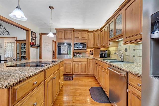 5335 Catawba Valley Dr, Catawba, VA 24070 - kitchen with stainless steel appliances, light stone countertops, decorative backsplash, and light wood-style floors