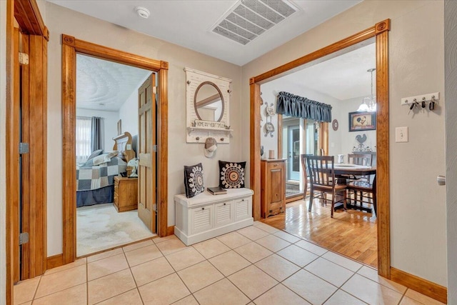 5335 Catawba Valley Dr, Catawba, VA 24070 - hallway featuring light tile patterned flooring and a chandelier