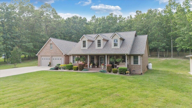 5335 Catawba Valley Dr, Catawba, VA 24070 - cape cod home with a porch, brick siding, driveway, a front lawn, and a garage