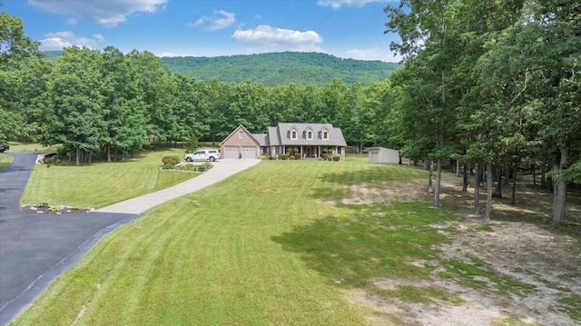 5335 Catawba Valley Dr, Catawba, VA 24070 - view of front of home with a wooded view, a front lawn, a storage unit, and driveway