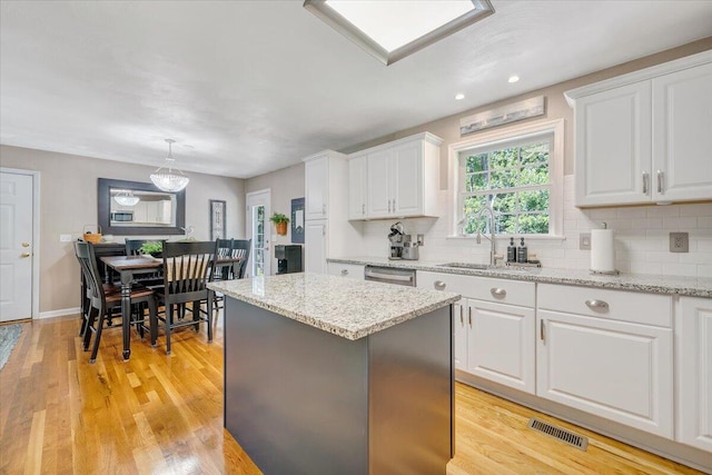 139 Lynville Dr, Hardy, VA 24101 - kitchen with a center island, white cabinets, tasteful backsplash, light stone countertops, and recessed lighting