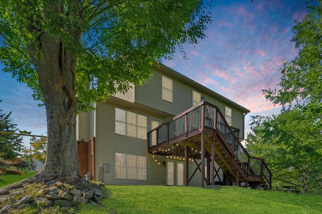 6061 Chagall Dr, Roanoke, VA 24018 - back of house at dusk featuring a wooden deck, stairs, and a lawn
