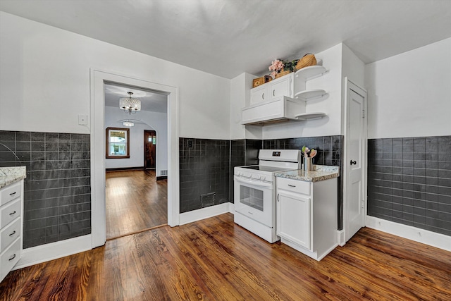 1618 8th St SE, Roanoke, VA 24013 - kitchen with electric range, tile walls, dark wood finished floors, arched walkways, and light stone counters