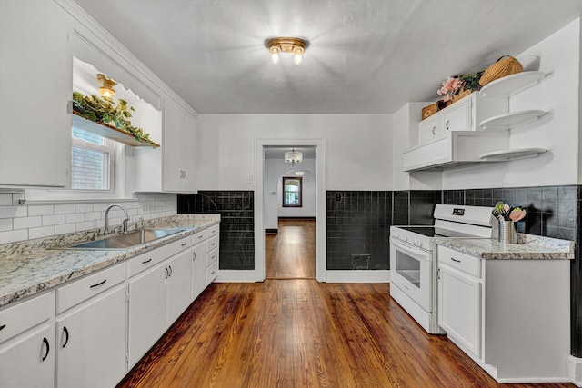 1618 8th St SE, Roanoke, VA 24013 - kitchen featuring white electric range, a sink, healthy amount of natural light, white cabinets, and tile walls