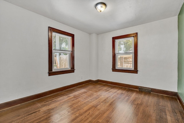 1618 8th St SE, Roanoke, VA 24013 - spare room with healthy amount of natural light, hardwood / wood-style floors, and baseboards