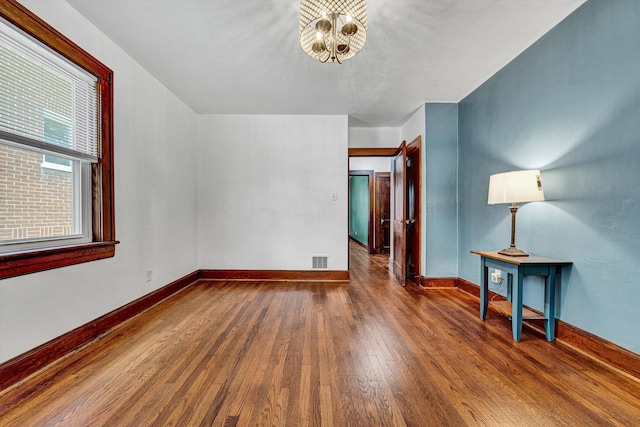 1618 8th St SE, Roanoke, VA 24013 - unfurnished room featuring wood-type flooring, a chandelier, and baseboards