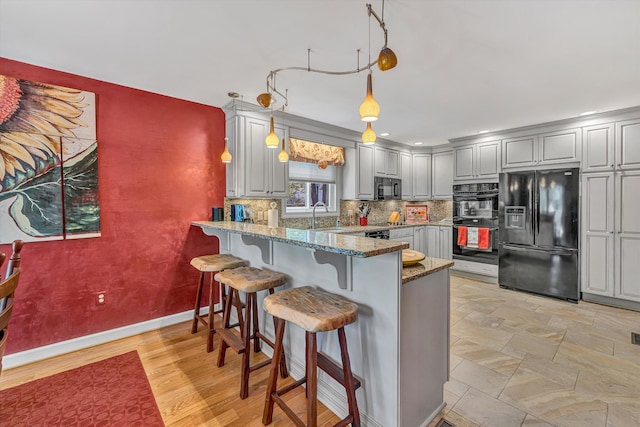 200 Fairway Dr, Penhook, VA 24137 - kitchen featuring black appliances, a sink, gray cabinetry, a peninsula, and light stone countertops