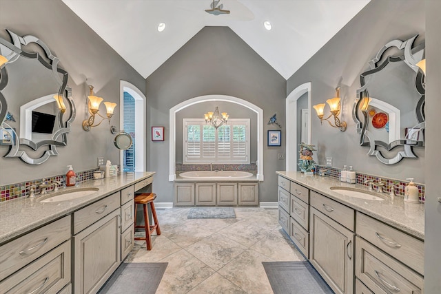 200 Fairway Dr, Penhook, VA 24137 - bathroom with a chandelier, two vanities, a bath, tasteful backsplash, and high vaulted ceiling