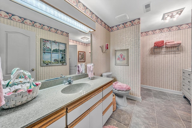 200 Fairway Dr, Penhook, VA 24137 - bathroom with toilet, vanity, stone finish flooring, wallpapered walls, and baseboards