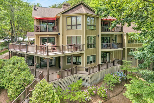 200 Fairway Dr, Penhook, VA 24137 - rear view of property with a balcony, a chimney, and roof with shingles