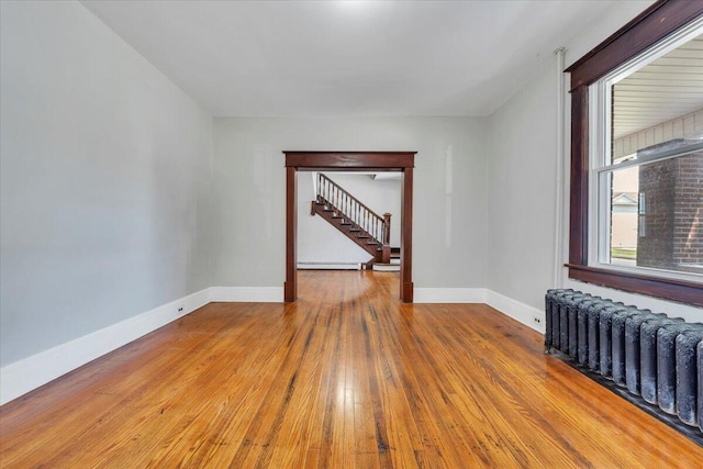 1523 Rorer Ave SW, Roanoke, VA 24016 - spare room with radiator, hardwood / wood-style floors, stairway, and baseboards
