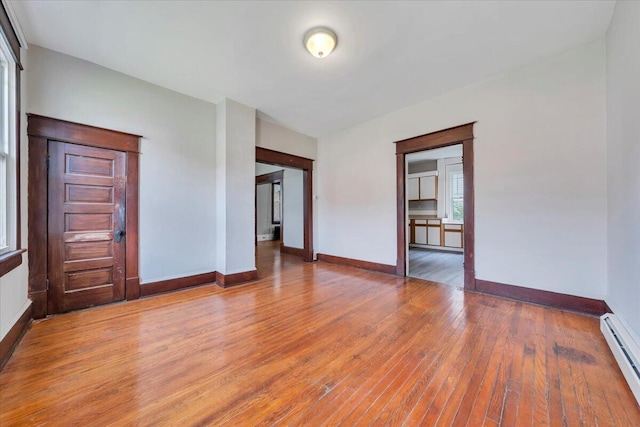 1523 Rorer Ave SW, Roanoke, VA 24016 - unfurnished room featuring a baseboard heating unit, light wood-type flooring, and baseboards