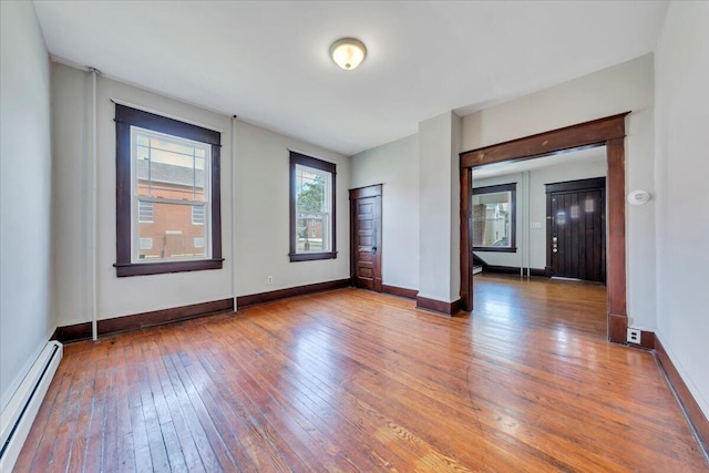 1523 Rorer Ave SW, Roanoke, VA 24016 - empty room featuring baseboard heating, hardwood / wood-style floors, and baseboards