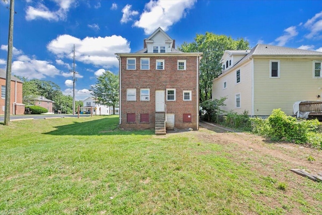 1523 Rorer Ave SW, Roanoke, VA 24016 - rear view of property featuring entry steps, brick siding, and a yard