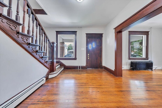 1523 Rorer Ave SW, Roanoke, VA 24016 - foyer featuring radiator heating unit, a baseboard heating unit, wood finished floors, and healthy amount of natural light