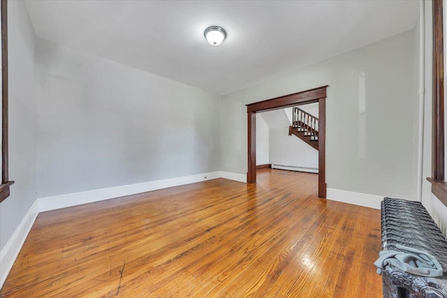 1523 Rorer Ave SW, Roanoke, VA 24016 - unfurnished room featuring baseboard heating, wood finished floors, stairs, and baseboards