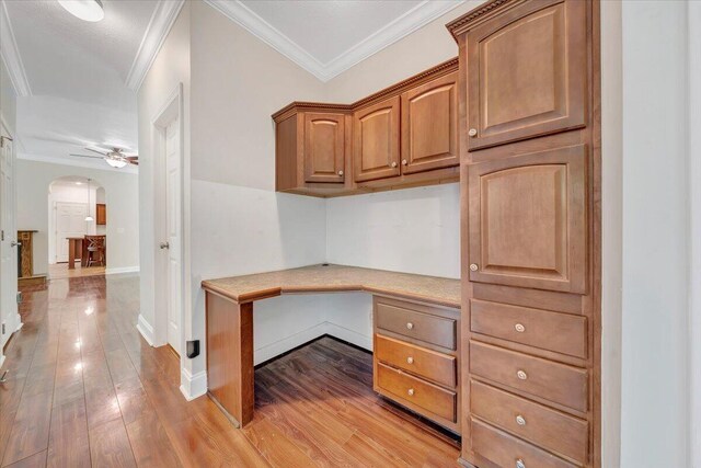 5995 Twine Hollow Rd, Salem, VA 24153 - unfurnished office featuring built in study area, arched walkways, ceiling fan, light wood-type flooring, and crown molding