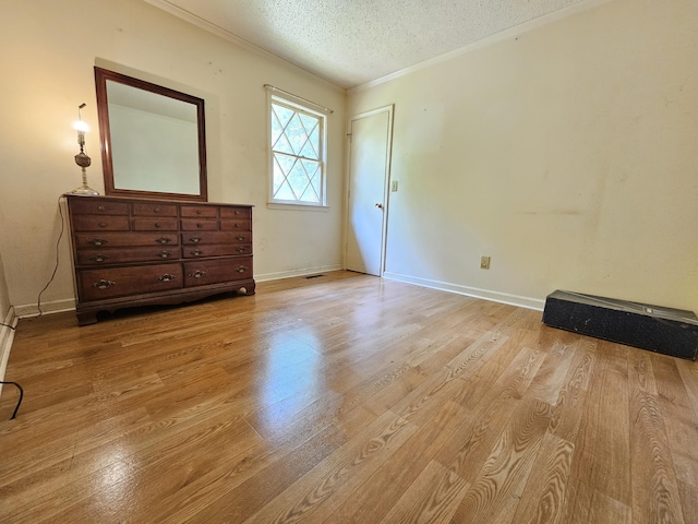 3 Pine Ln, New Castle, VA 24127 - unfurnished bedroom with light wood-style flooring, crown molding, a textured ceiling, and baseboards