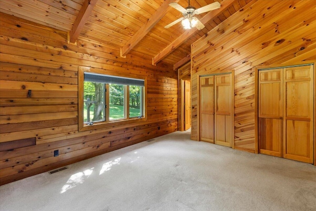 612 Peters Creek Dr, Stuart, VA 24171 - unfurnished bedroom with wood ceiling, wood walls, light colored carpet, and multiple closets