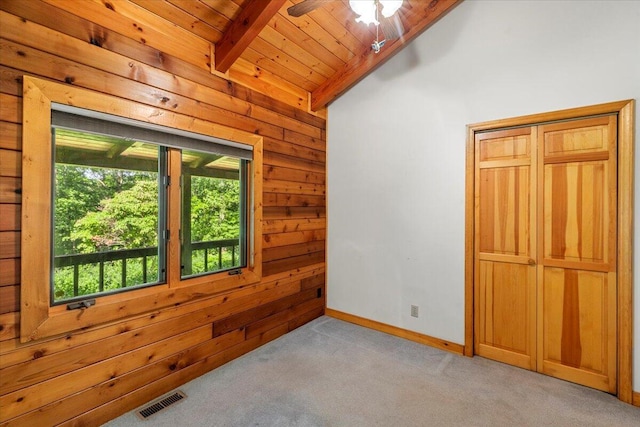 612 Peters Creek Dr, Stuart, VA 24171 - spare room featuring light carpet, wooden walls, wooden ceiling, and ceiling fan