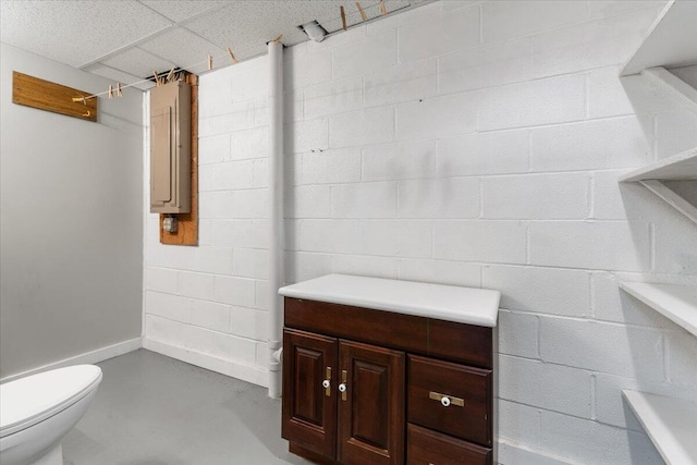 612 Peters Creek Dr, Stuart, VA 24171 - bathroom with a drop ceiling, concrete block wall, concrete flooring, and electric panel