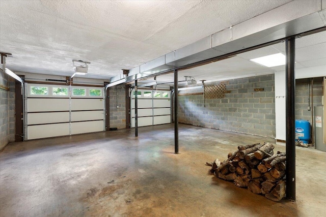 612 Peters Creek Dr, Stuart, VA 24171 - garage with concrete block wall and a garage door opener