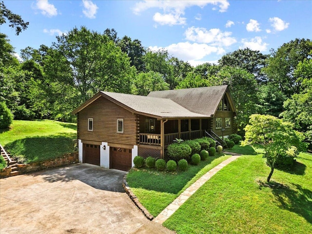 612 Peters Creek Dr, Stuart, VA 24171 - log home with log siding, concrete driveway, a garage, and a front yard