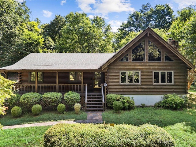 612 Peters Creek Dr, Stuart, VA 24171 - log home with log siding, a front yard, a chimney, and covered porch